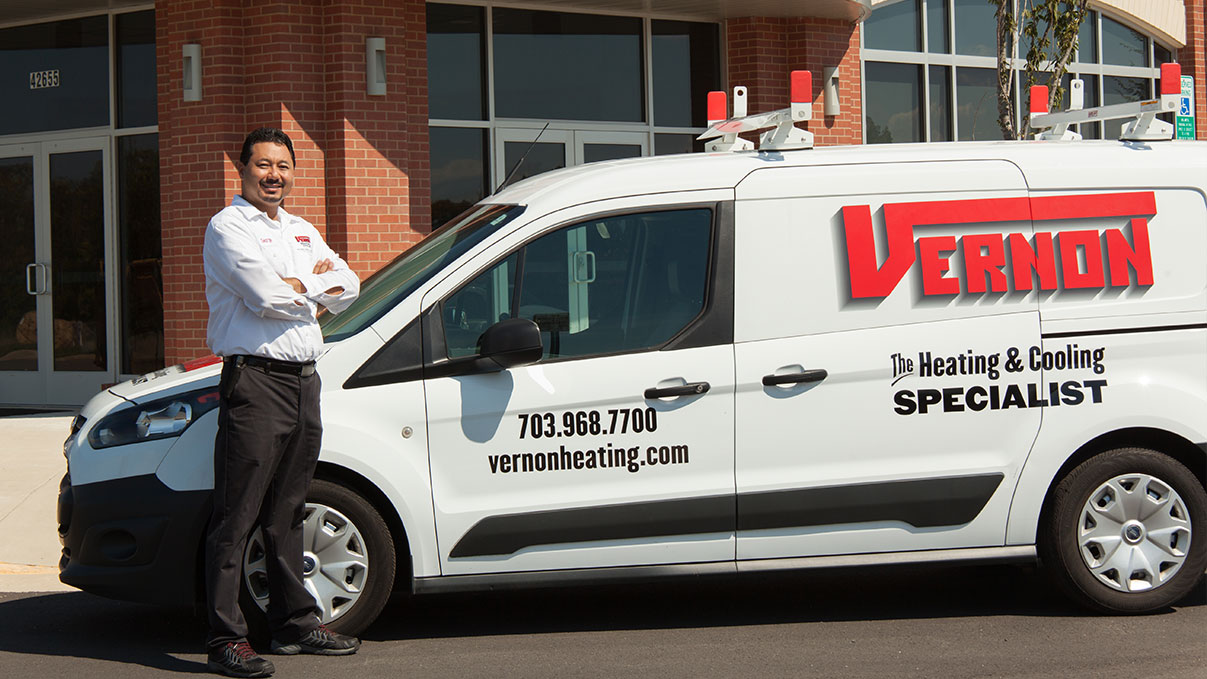 ac technician standing by van