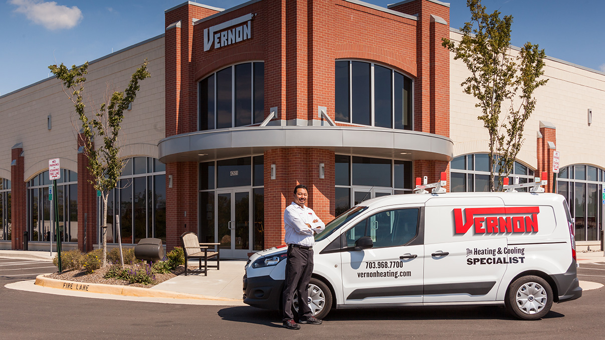 tech in front of building