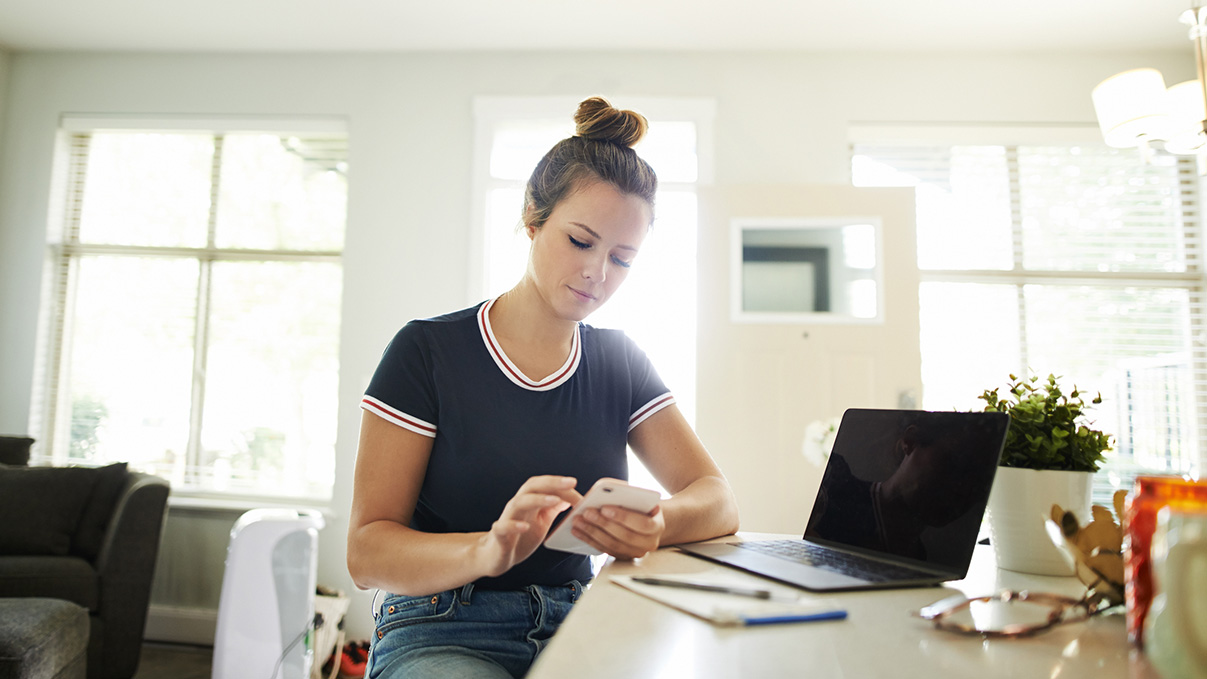 woman on her phone and computer