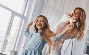 Mother Daughter Dancing In Home