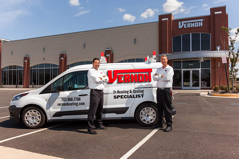 ac techs standing in front of Vernon The Heating & Cooling Specialist