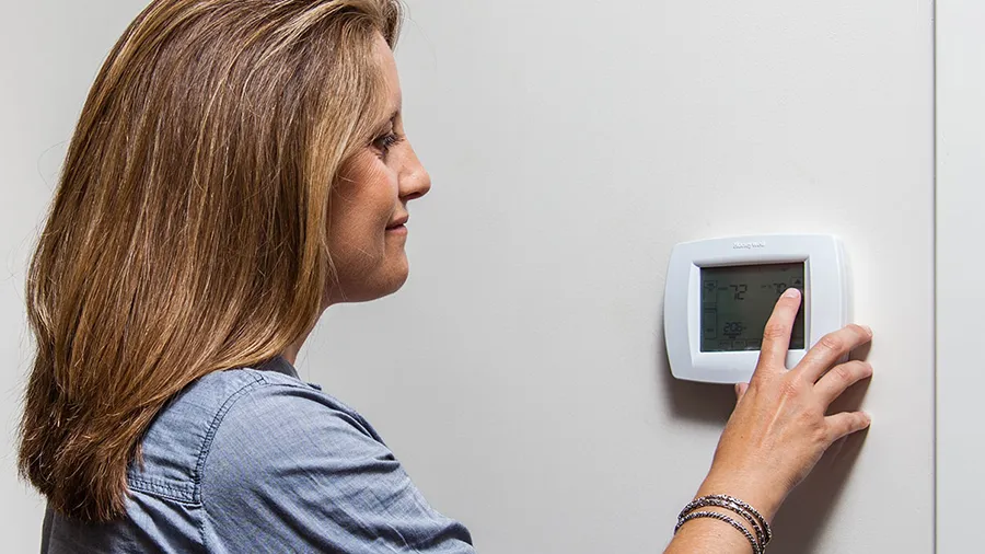 Woman At Thermostat